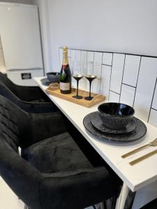 a table with two glasses and a bottle of wine at Impeccable 3-Bed House in Walsall in Walsall