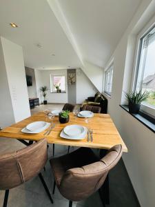 comedor con mesa de madera y sillas en Apartment Ihm AI en Benningen