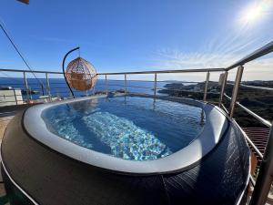 a hot tub on the deck of a house at OMG in Agia Pelagia