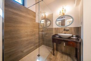 a bathroom with a sink and a glass shower at Casa Letizia in Taormina
