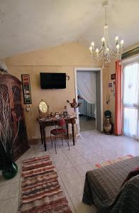 ein Wohnzimmer mit einem Tisch und einem Kronleuchter in der Unterkunft In Battaglino in Cascina