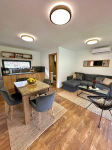 a living room with a table and a couch at Aqua Vita Concept in Bihać