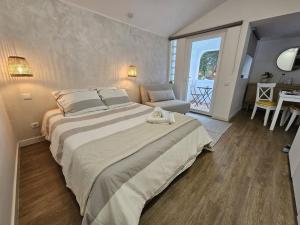 a large bedroom with a large bed and a table at Casa da Aldeia in Olhos de Água