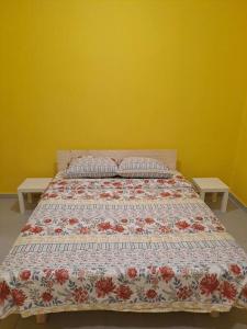 a bed in a bedroom with two tables at Fellini Marcello garden (talpiot) in Haifa