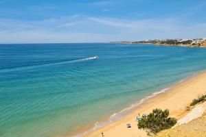 a boat in the water on a beach at Casa da Aldeia in Olhos de Água +19 photos
