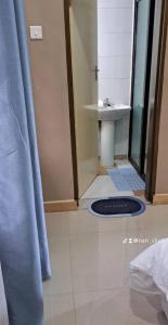 a bathroom with a sink and a blue shower curtain at 11036 in Ndola