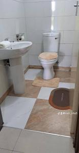 a bathroom with a toilet and a sink at 11036 in Ndola