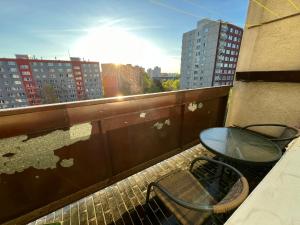 a table and chairs on a balcony with buildings at Apartment Maluchy in Hrabŭvka