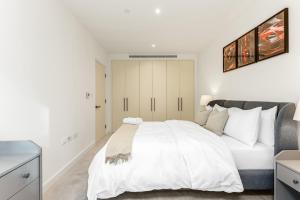 a white bedroom with a large white bed in it at Khayat Homes - The Lord - One Bed Luxury Apt in London
