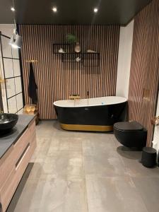 a bathroom with a tub and a toilet in it at Exclusive view villa in Tromsø +19 photos