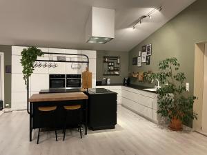 a kitchen with black and white cabinets and a counter at Exclusive view villa in Tromsø