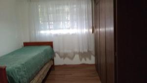 a bedroom with a bed and a window with curtains at La Plata 1643 in La Plata