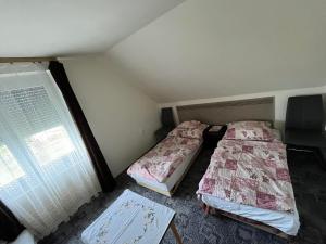 A bed or beds in a room at Talabér Vendégház