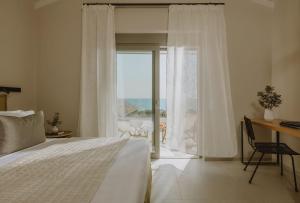 a bedroom with a bed and a view of the ocean at Sophisticated Preveza Villa Villa Harmony 2 Bedrooms Breathtaking Ionian Sea View And Private Pool Kanali Beach in Preveza