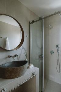 a bathroom with a sink and a shower with a mirror at Sophisticated Preveza Villa Villa Harmony 2 Bedrooms Breathtaking Ionian Sea View And Private Pool Kanali Beach in Preveza