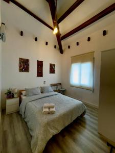 a bedroom with a large bed with two towels on it at Villa Paradise, urban oasis by -Toprentalsbarcelona- in Esplugues de Llobregat