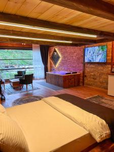 a bedroom with a large bed in a room at Dayf Suit Naliya Otel in Çamlıhemşin