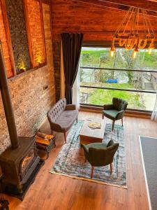 a living room with a fireplace and a stove at Dayf Suit Naliya Otel in Çamlıhemşin