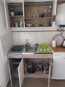 a small kitchen with a sink and a counter at House 23 A2 in Tivat +6 photos