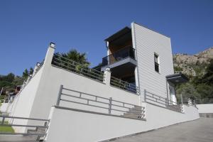 a white building with stairs and a balcony at Marin Villaları Villa-2 in Marmaris