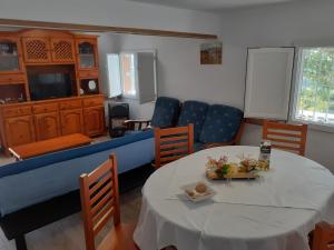 a living room with a couch and a table and chairs at Apartamentos Santillán in San Vicente de la Barquera