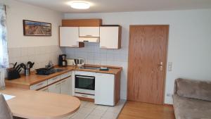 a kitchen with a sink and a stove top oven at Ferienwohnung für 5 Personen in Wasserburg in Wasserburg am Bodensee