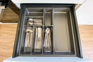 a black tray with utensils in it at 120 Lux Furnished flat in Beaufort
