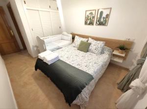 a bedroom with a large bed and a window at Dunas de Águilas in Águilas +7 photos