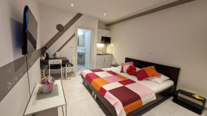 a bedroom with a bed and a desk in it at Vitis Apartments in Zaton