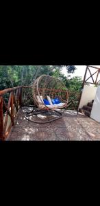 a wicker chair sitting on top of a deck at Villa luna y sombra in Tulum