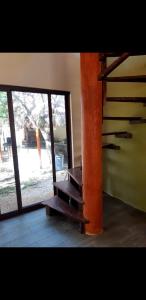 an empty room with a glass door and a stair case at Villa luna y sombra in Tulum