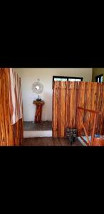 a room with wooden curtains and a wooden table at Villa luna y sombra in Tulum