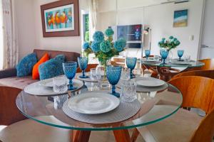 a dining room with a glass table and chairs at Beautiful floor 9th apartment Pool Gym Barranco in Lima