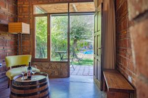 a room with a table and a chair and a window at Posada Boutique El Encuentro Chacras de Coria in Chacras de Coria