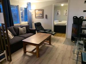 a living room with a couch and a coffee table at Velkommen til en koselig leilighet på Sørlandet! in Kristiansand