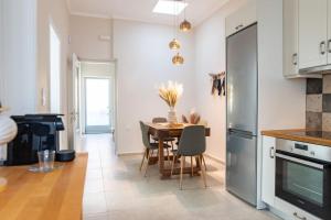 a kitchen and dining room with a table and chairs at Ki.Kos - Private House in Kos