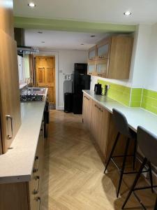 a kitchen with wooden cabinets and a counter top at Entire house in Liverpool in Litherland
