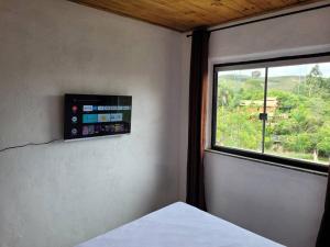 a bedroom with a window with a view of a mountain at Casa em Lavras Novas in Ouro Preto