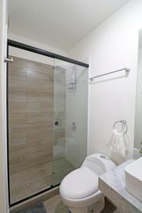 a bathroom with a toilet and a glass shower at Beautiful floor 9th apartment Pool Gym Barranco in Lima