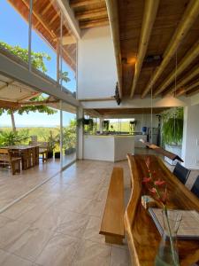 an open living room with a wooden table and a dining room at Casa Cosmonova in Puerto López