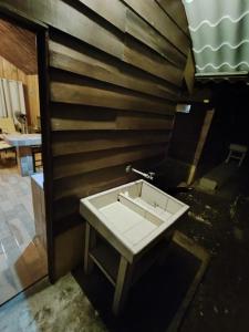 a bathroom with a sink and a wooden wall at Las Cabañas in Venecia