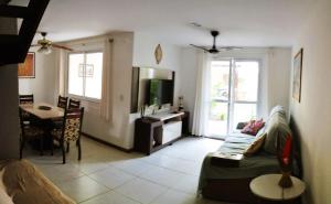 a living room with a couch and a table at Residence Cotê d' Azur in Imbassai