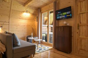 a living room with a couch and a small table at Cottages Relax in Jajce