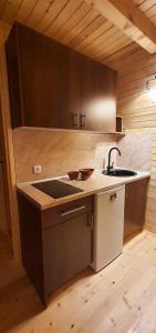 a kitchen with a sink and a counter top at Cottages Relax in Jajce