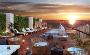 a rooftop patio with chairs and tables on a building at Beautiful floor 9th apartment Pool Gym Barranco in Lima