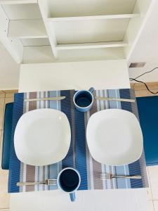 two white chairs sitting on a rug in a room at Tiny house Santa Ana in Santa Ana