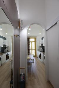 a kitchen and dining room with a table and a mirror at Maison Sara in Bari