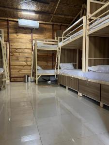 a room with two bunk beds in a building at Jeet Hostel & Rooms in Canacona