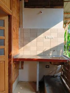 a kitchen with a counter top in a room at Jeet Hostel & Rooms in Canacona