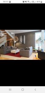 a living room with two couches and a staircase at Cozy Apartment In Pietarsaari in Pietarsaari